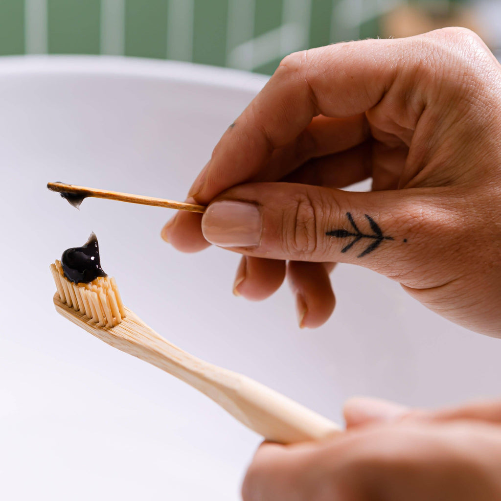  Vegan toothpaste on a bamboo toothbrush, with charcoal formula and animal cruelty-free label